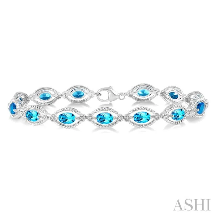 1/10 Ctw Round Cut Diamond & 6x4MM Oval Cut Blue Topaz Semi Precious Bracelet in Sterling Silver