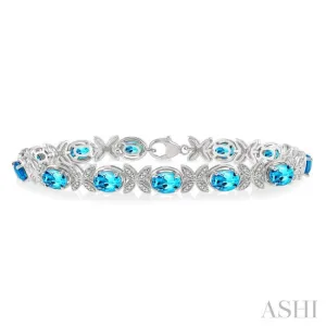 1/10 Ctw Round Cut Diamond & 7x5 MM Oval Cut Blue Topaz Semi Precious Bracelet in Sterling Silver